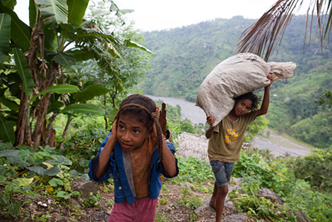 Isabel's oldest daughter Natalina* (right) often works up to 12 hours a day as well as attending school and studying.