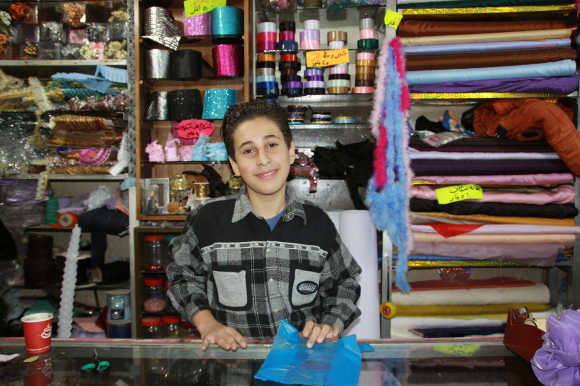 Abu*, aged 13, works more than twelve hours every day so his family can survive: “For me the worst thing is to see the pain in my parents’ eyes when I come home from work. I can see and hear how their hearts are breaking when they look at me. I want to feel safe again. One day I want to become a pilot and only enter shops, like the one I am working in now, when I want to buy something.” © CARE/Johanna Mitscherlich
