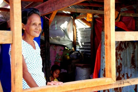 Remedios Petilla, 70, stands proudly in her home which was re-built using a shelter repair kit provided by CARE and our partner ACCORD following Typhoon Haiyan in the Philipines. Image: CARE.