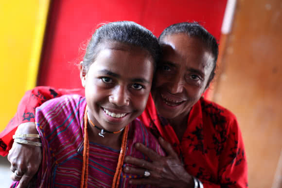 Palmira Sanches won an award for being a role model parent in one of CARE's education projects in Timor-Leste. Palmira encourages her daughter Fidelia* to go to school, even tough many girls in Timor-Leste miss out on an education in order the help their families work or look after the house. Image: Josh Estey/CARE.