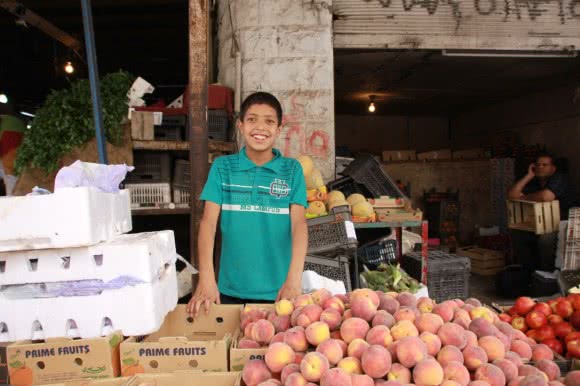 To support his family Aboud works in a vegetable store 12 hours every day.