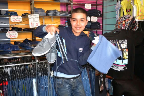 Abu was very happy to buy a new pair of jeans, flip-flops, shirt, socks and sneakers.