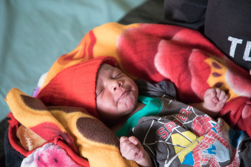 Anita's daughter is one day old and able to receive a polio vaccination thanks to CARE