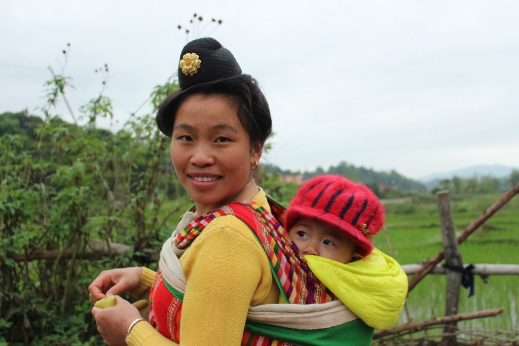 mother carrying young baby in Vietnam