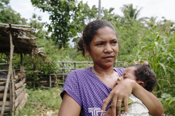 Amelia Saramento, 32, and baby Antonio. Aldeia Kota-Foun, Suco Lalawa, Suai, Timor Leste.