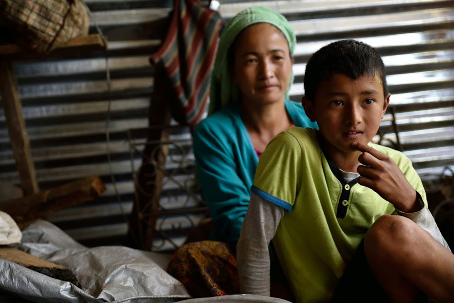 Ittha Kumari sits with her son who is about to start back at school. Photo: © Lucy Beck/CARE
