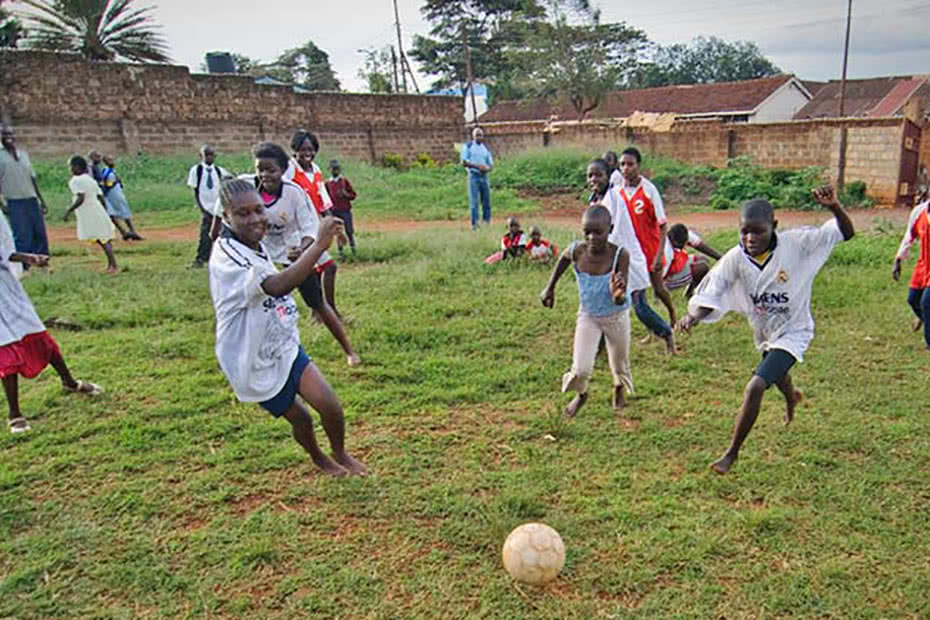 Girls and boys play soccer in Tanzania.