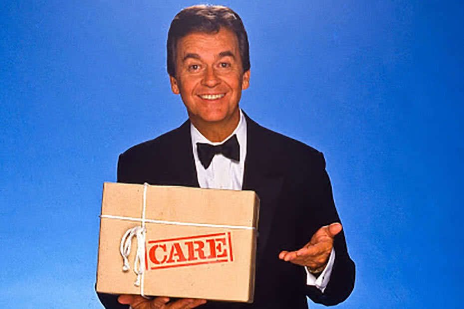 Historical image of American television personality Dick Clarke with a CARE package.