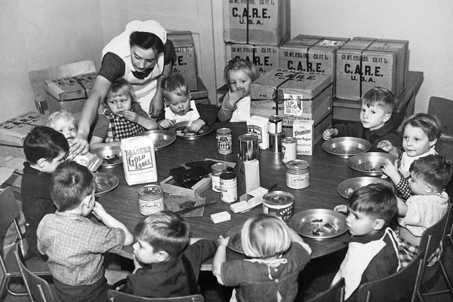 A historical photo of Dutch orphans being fed with CARE packages.