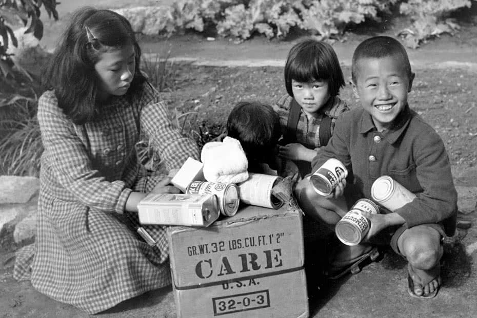 Historical photo of a Japanese family receiving CARE packages.