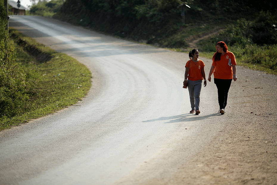 Meagan (pictured right) speaks with local CARE Laos staff. © Josh Estey/Laos