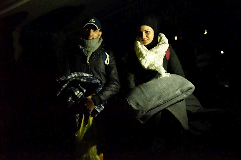 Syrian refugees and newlyweds Noor and Amfiraz with emergency supplies provided by CARE.