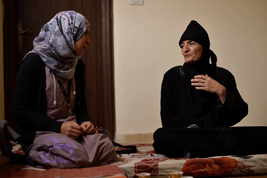 Syrian refugee Amira* (pictured right) speaks to local CARE staff.