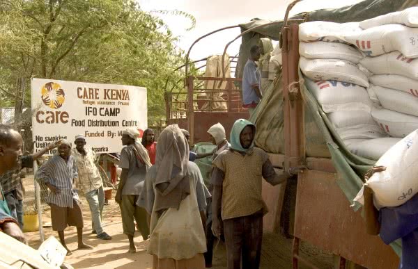 Workers preparing to unload bags of food at the Dadaab refugee camp in Kenya. Over 1,500 Somali refugees were arriving daily as a result of the ongoing drought. CARE distributed emergency food rations, blankets, water containers, sleeping mats and plastic sheets.