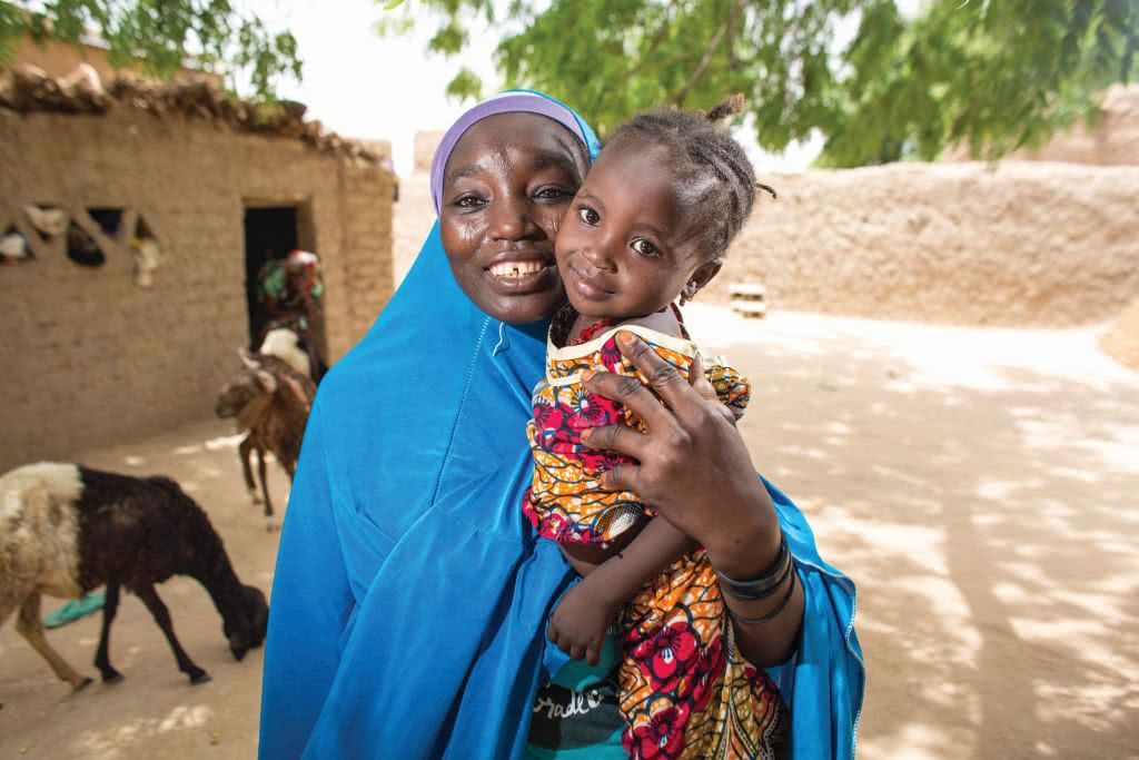 Haoua from Kagadama village outside Maradi City in Niger, poses for a picture with her daughter outside her home. Haoua is the daughter of Fatchima Aboubacar, a member of the first Village Savings and Loan Association (VSLA), also known as "Mata Masu Dubara" (MMD), which began in 1991. She was married early (Niger has the highest percentage of child brides in the world) and was unable to go to school. She says VSLA (MMD), however, has taught her the value of education, and though one of her own children was married at 15 and is not in school, her other five children are getting the education that she knows will bring them more opportunities than she had. “My kids will be stronger than my generation, and their kids stronger than theirs,” she says.