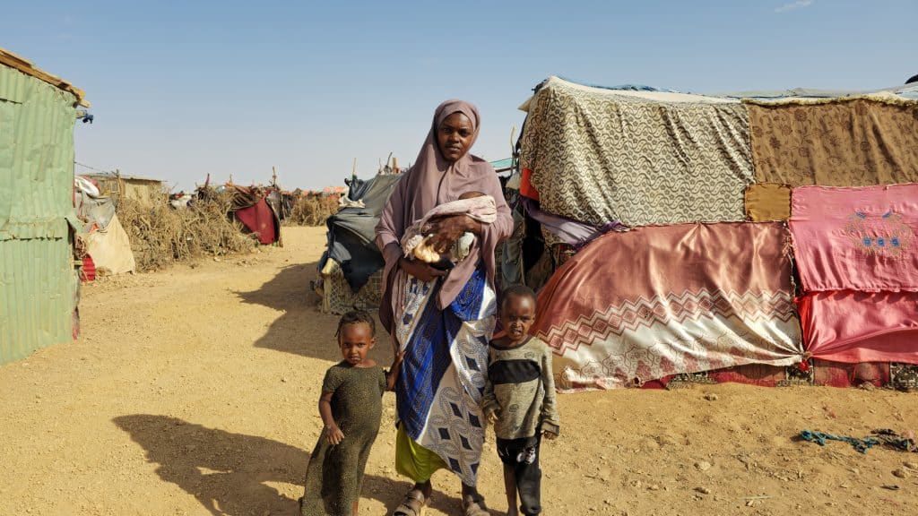 Khadra and her three children at the camp.